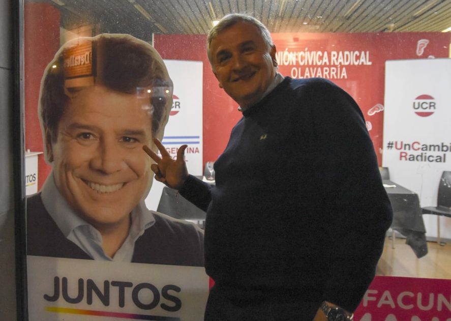 Gerardo Morales bromea junto a una foto de Facundo Manes luego de la conferencia realizada en uno de sus locales partidarios 